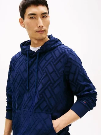 Hoodie i velourjacquard med flagglogo över hela plagget