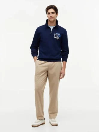 Polo-tröja med blommig logotyp och kvartslång dragkedja