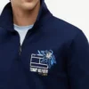 Polo-tröja med blommig logotyp och kvartslång dragkedja Polo-tröja med blommig logotyp och kvartslång dragkedja