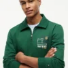 Polo-tröja med blommig logotyp och kvartslång dragkedja Polo-tröja med blommig logotyp och kvartslång dragkedja