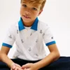 Stretchpolo med nautiskt logo-mönster för barn Stretchpolo med nautiskt logo-mönster för barn