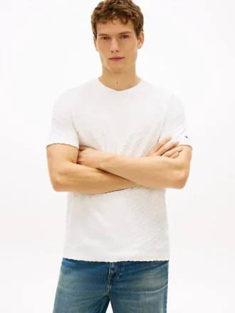 T-shirt med jacquardmönster och flagglogo över hela plagget